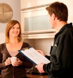 ENW staff talking to a customer in their kitchen