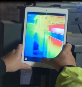 engineer holding ipad with heat signature on the screen