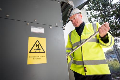 Engineer replacing ageing equipment at local substations