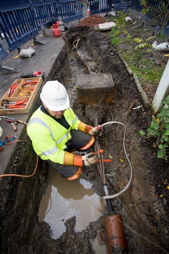 Engineer installing underground power cable