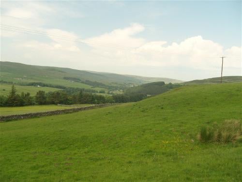 View of green hills in the North Pennines with overhead power lines