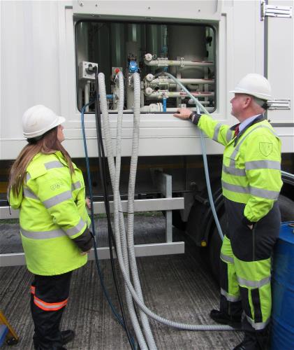 Two engineers looking at a transformer