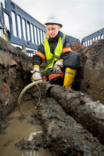 Engineer installing underground power cable