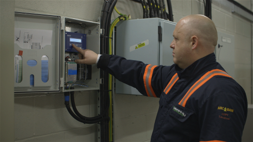 ENW engineer installing an enhanced voltage controller